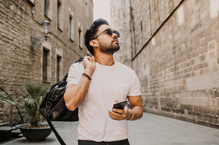 Young urban professional man using stock photo containing phone and people