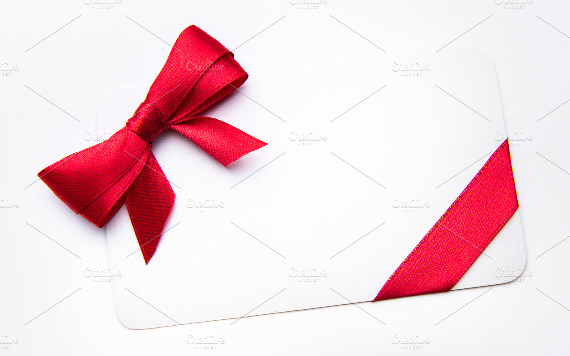White card with red ribbon bow for celebration, a Holiday Photo by Olena Rudo