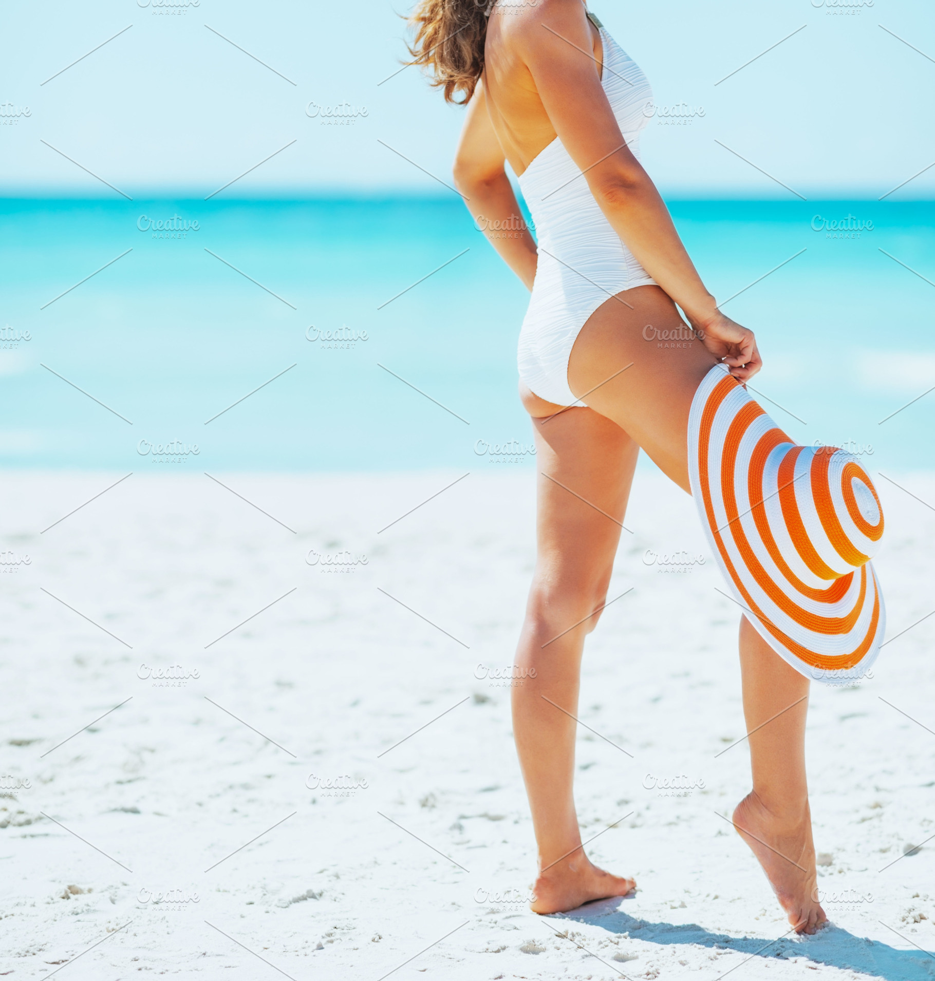 Closeup on smiling young woman with hat on beach, a Person Photo by Alliance Images
