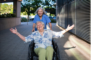Aging woman in wheelchair enjoying, a Health & Medical Photo by HalfPoint