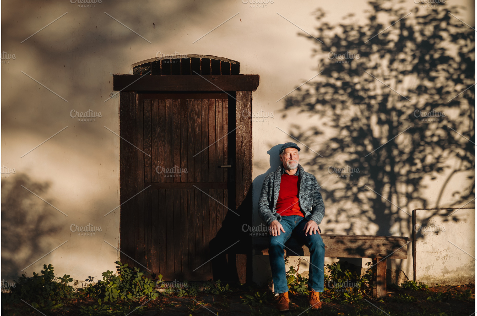 Older man enjoying warm autumn sun, a Person Photo by HalfPoint