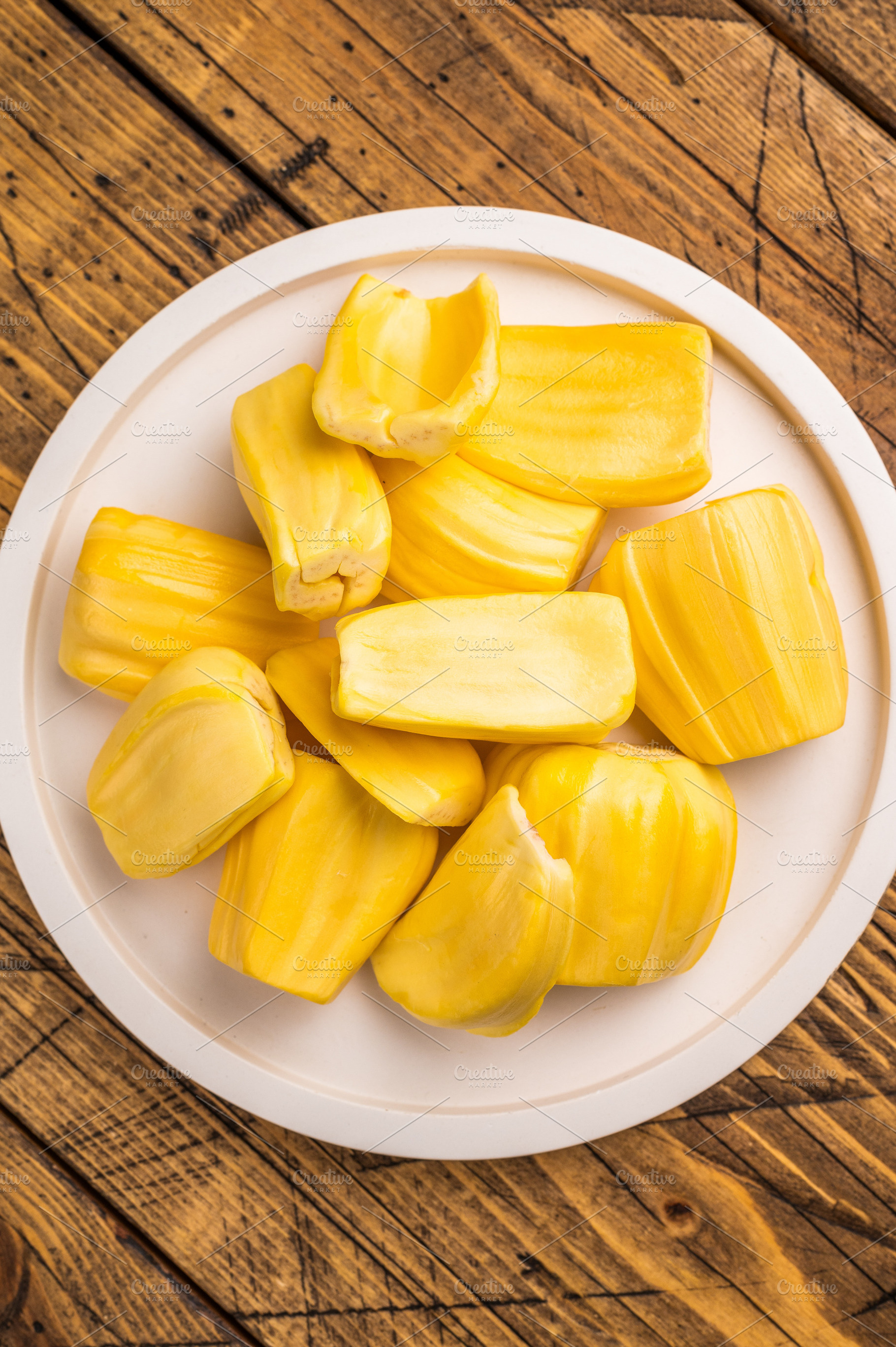 Sweet, golden yellow jackfruit pods (bulbs) served on a white pl, a Photo by composter-box@mail.ru