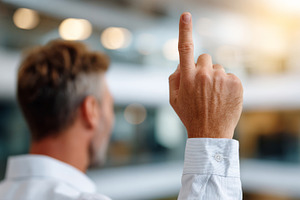 A confident middle-aged Caucasian man raises his finger, signaling a bright ide, a Person Photo by ImageMir