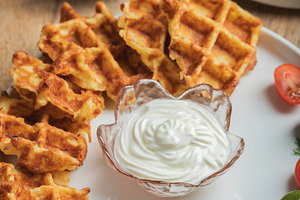 Top view of Homemade Potato Waffles, ricotta cheese and mayonese sauce. Served, a Food & Drink Photo by Budarinphoto