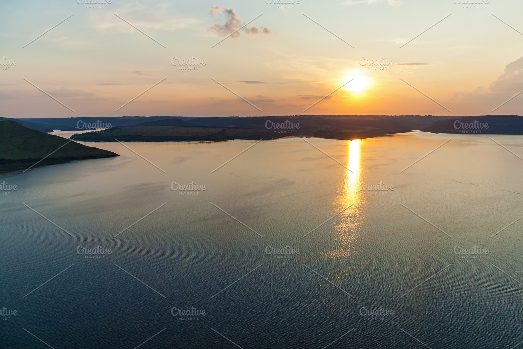 Sunset reflection over calm river landscape, a Nature Photo by Photostock