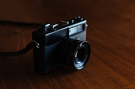 Vintage camera on a wooden table, a Technology Photo by OSORIOartist