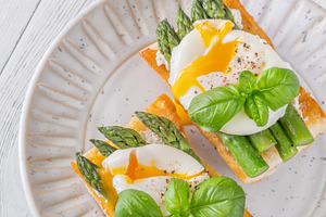 Gourmet Ciabatta Bruschetta With Runny Poached Eggs And Fresh As, a Food & Drink Photo by Alexander Prokopenko