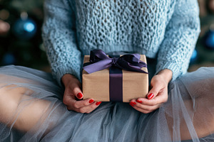 Brown paper gift in hand