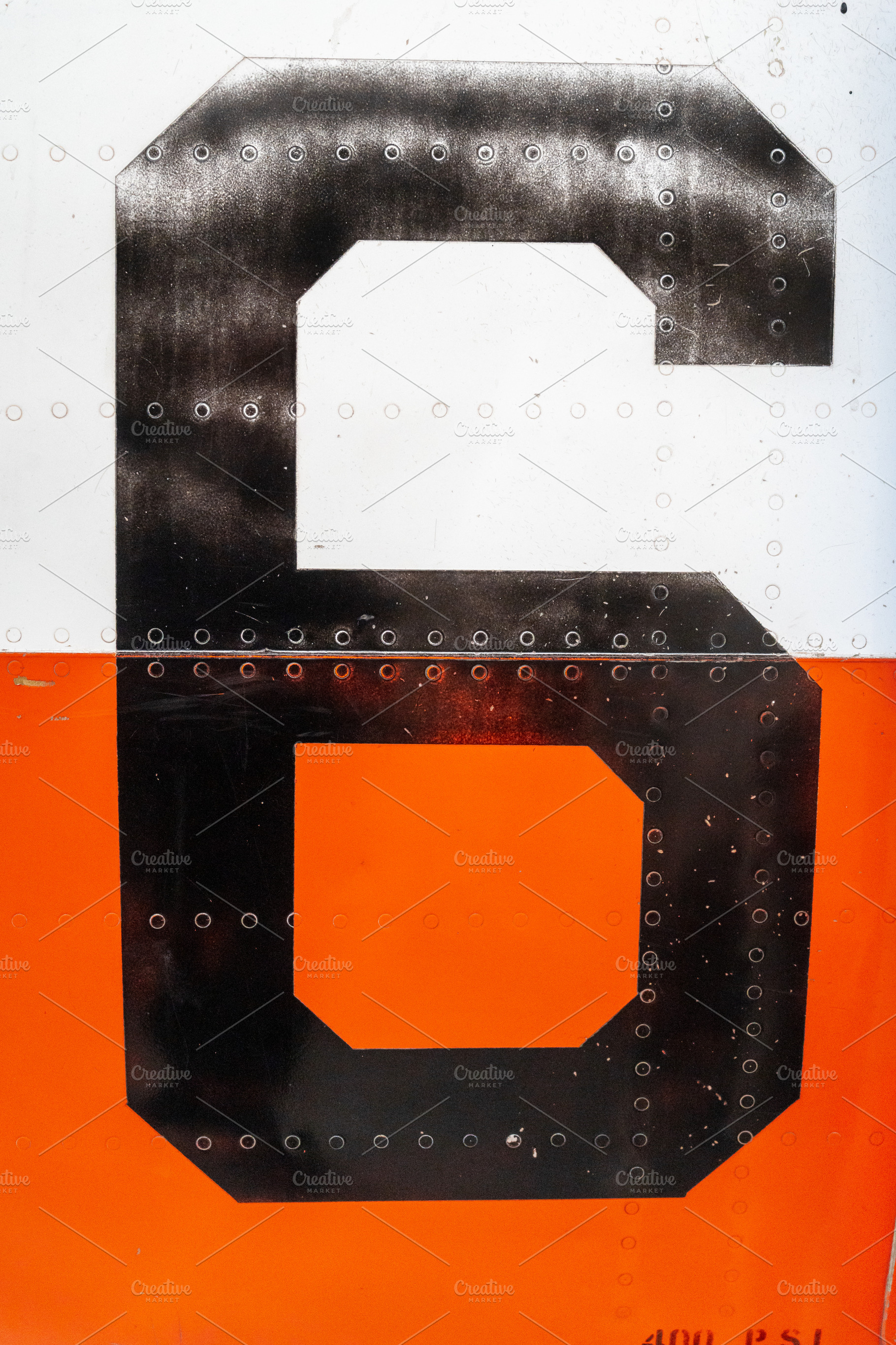 Large black number -6- on an old aircraft fuselage with rivets, a Background Photo by GoodGoods