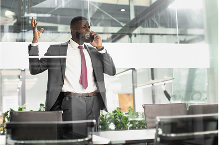 Furious black businessman talking on, a Person Photo by Prostock-Studio