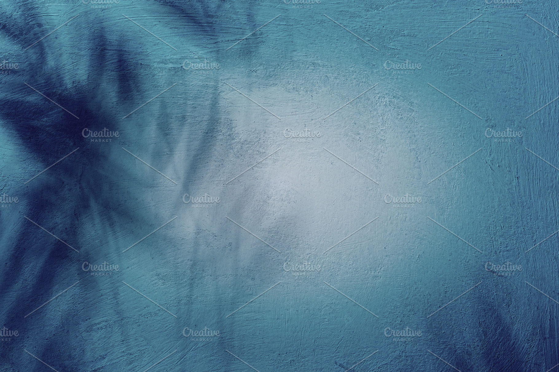 Textured blue concrete wall with soft falling shadow from tropic, an Abstract Photo by ndanko