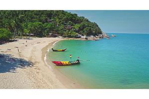 Tropical beach with colorful boats, a Nature Photo by Goinyk