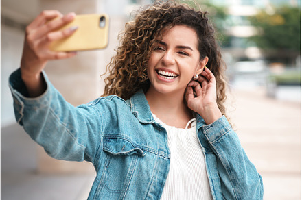 Young woman taking selfies with her, a Person Photo by Mego-studio