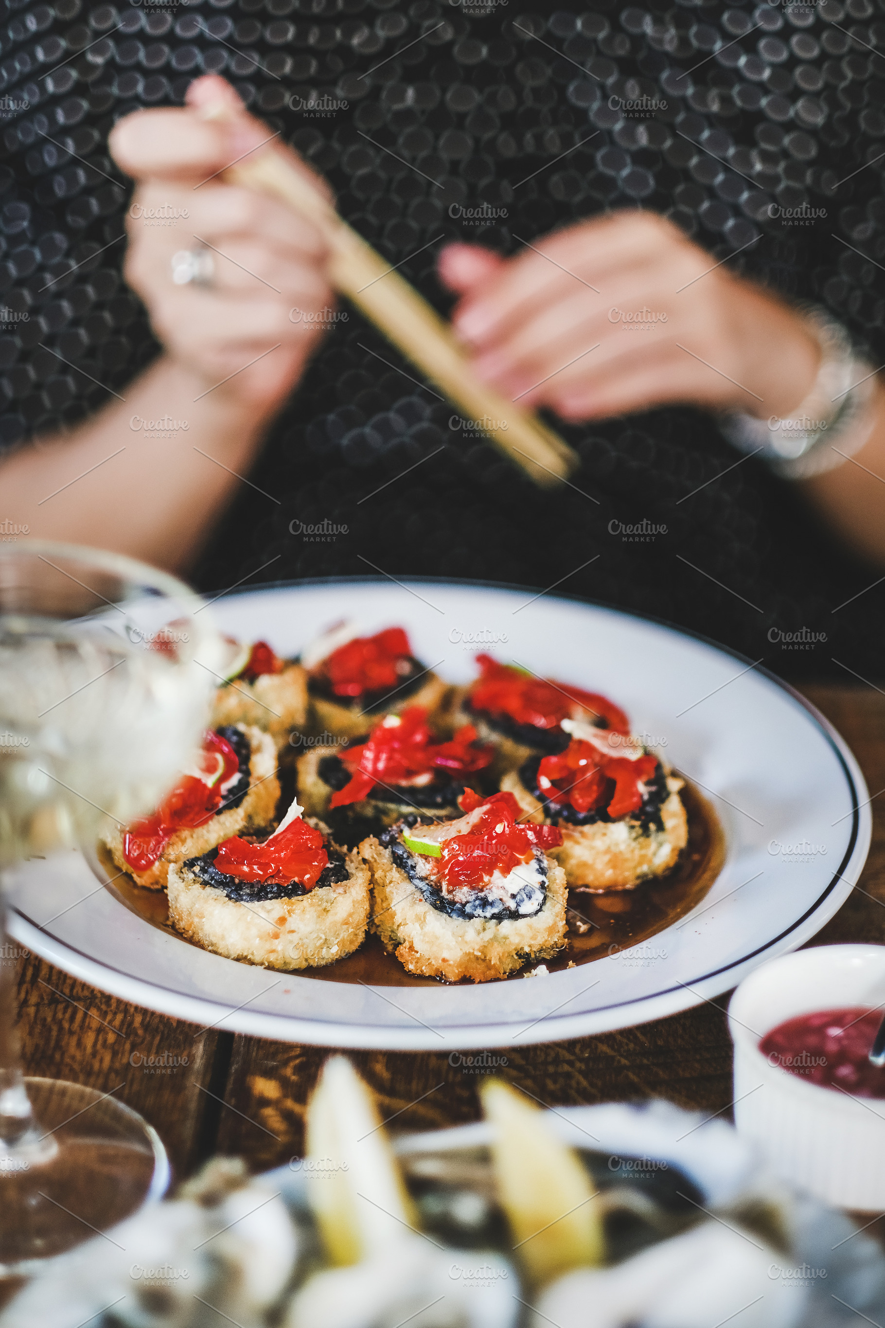 Girl eating baked sushi with, a Food & Drink Photo by Foxys