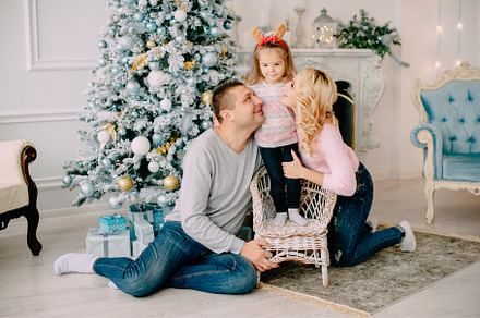 Young parents playing with baby near stock photo containing christmas and, a Holiday Photo by Maksym Zaitsev