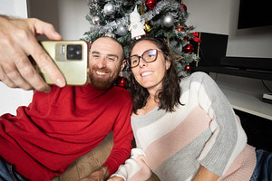 Couple Taking a Selfie with Their Christmas Tree, a Person Photo by etorres69