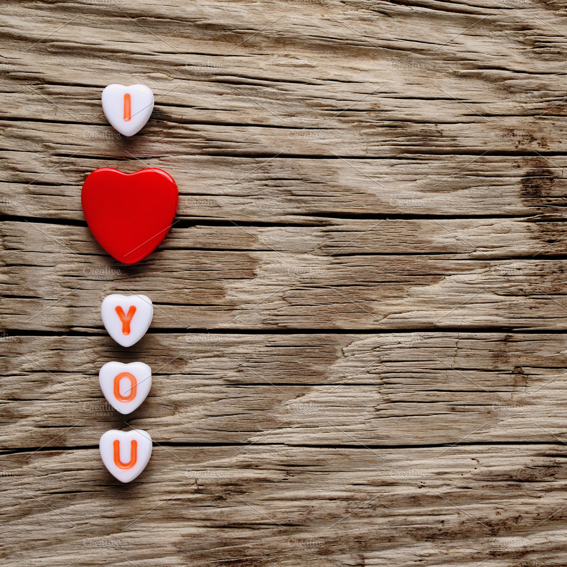 I love you text on miniature hearts featuring background, copyspace, and board