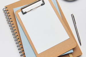 Clipboard, coffee, pen and notebook creating home office workspa, a Business Photo by Olena Rudo