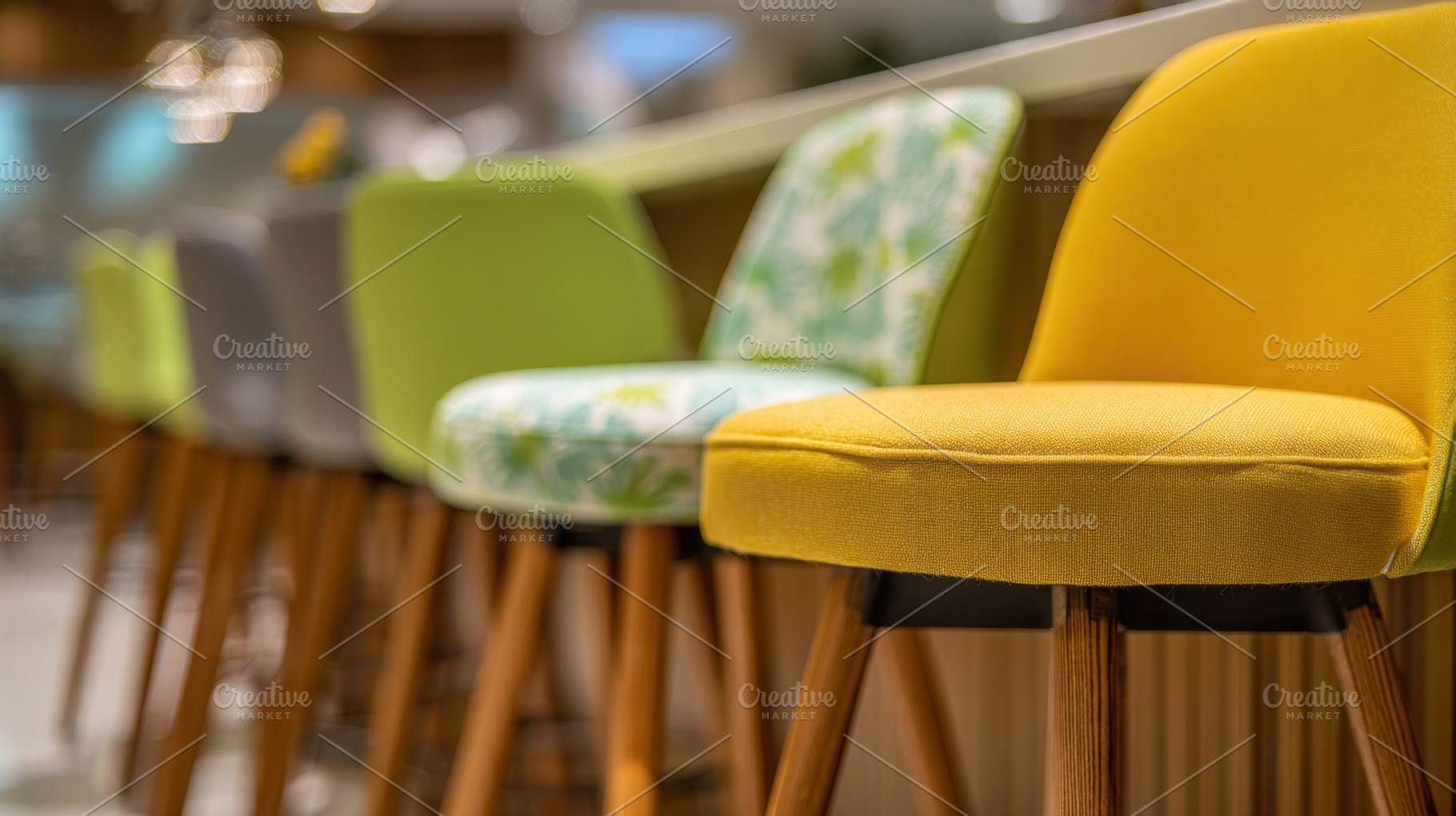 Colorful stools arranged at a bar, a Photo by Beautiful things