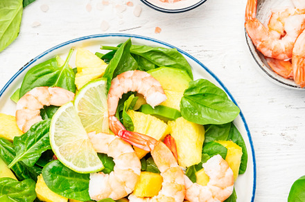 Fresh pineapple salad with shrimps, spinach, avocado and lime on, a Food & Drink Photo by 5PH