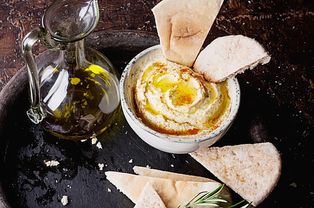 Middle east meze hummus featuring hummus, pita, and bread, a Food & Drink Photo by sebastianaraw