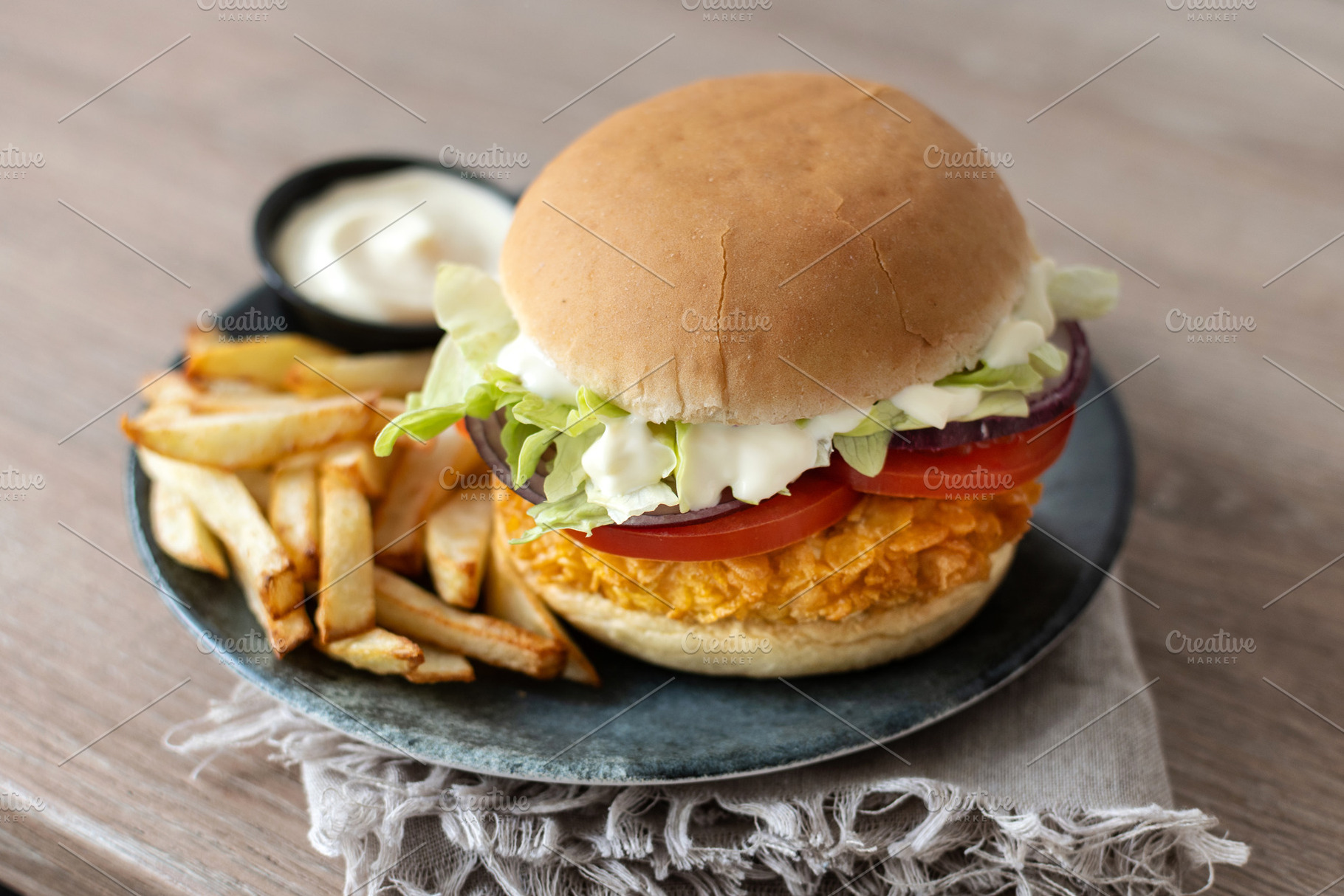 Crispy chicken burger with french fries and dipping sauce on plate, a Food & Drink Photo by etorres69
