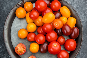 Colorful mix of cherry tomatoes in red yellow and orange tones a, a Food & Drink Photo by composter-box@mail.ru