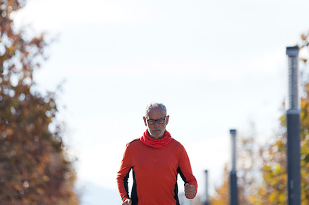 Senior man running outdoors in sportswear