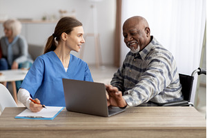 Friendly nurse assisting senior, a Person Photo by Prostock-Studio