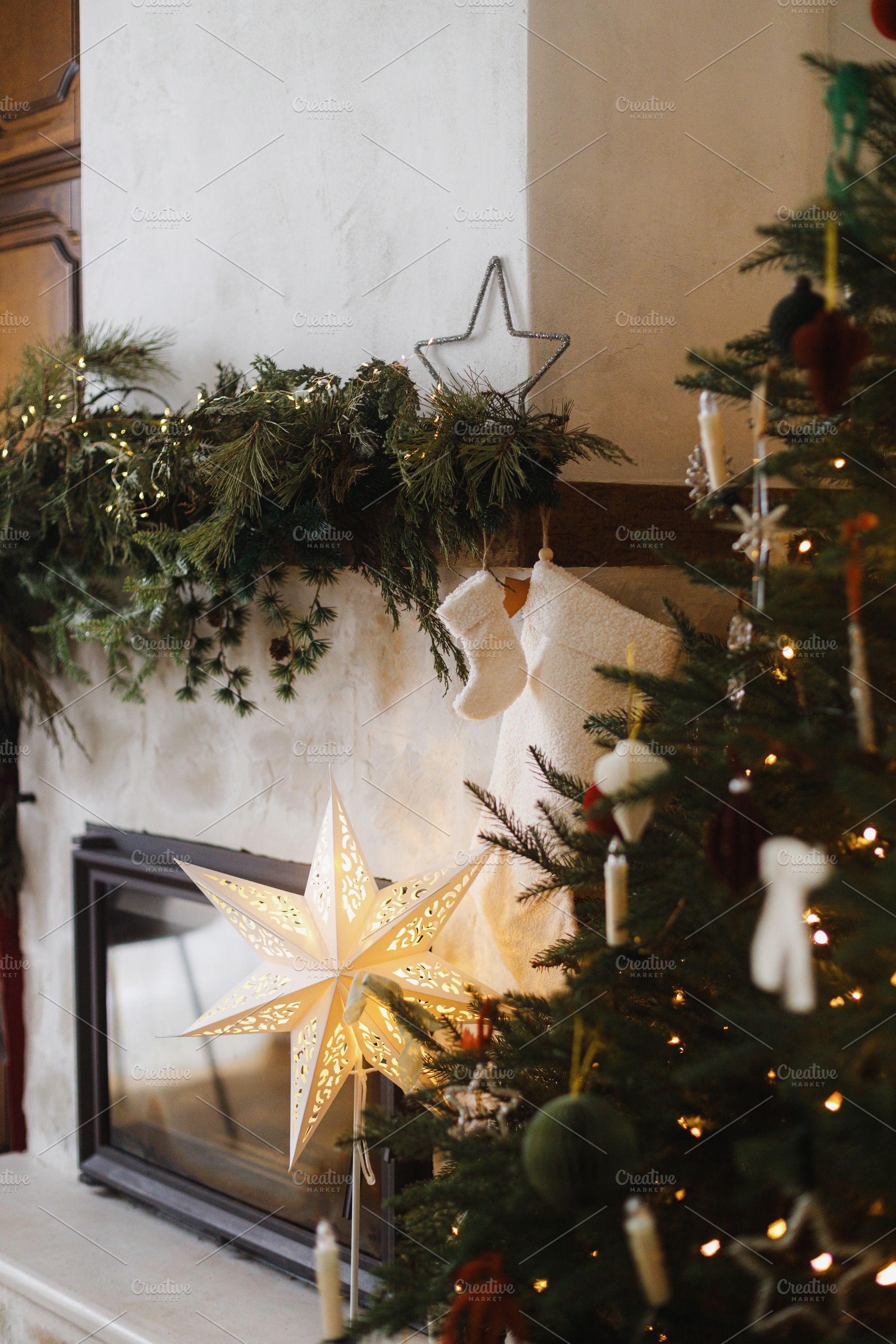 Stylish decorated christmas tree and fireplace mantel with stock, a Holiday Photo by Sonjachni