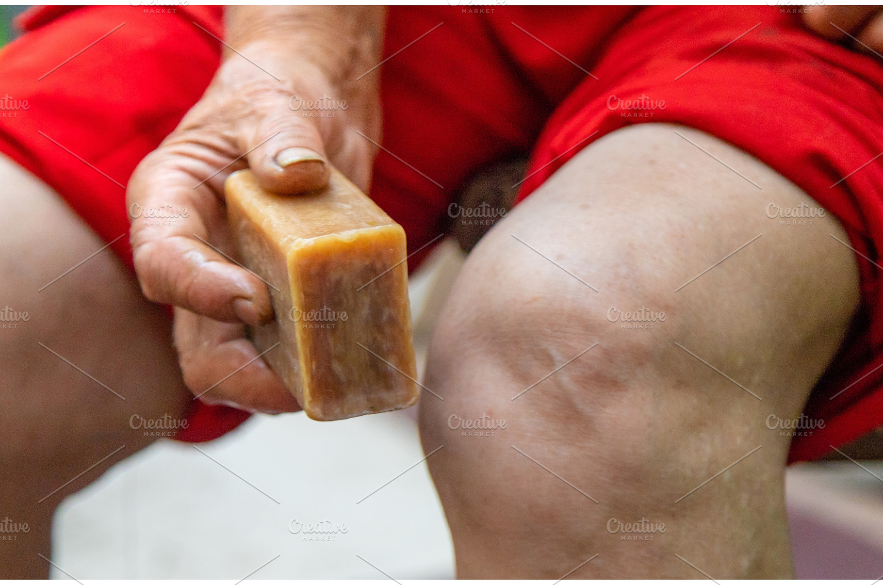 Grandmother treats her knees with, a Health & Medical Photo by yanadjana