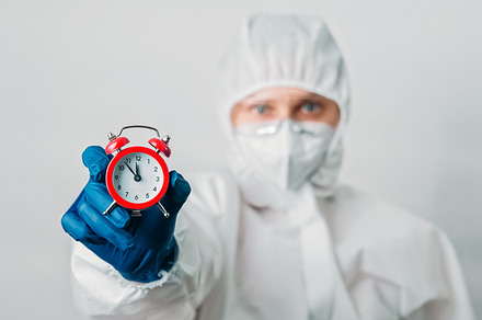 Checkup time countdown woman ppe suit alarm clock, a Health & Medical Photo by Photo Drive Studio