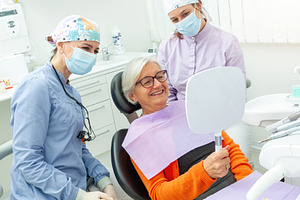 Senior woman admiring her smile after dental checkup, a Health & Medical Photo by Antonio Gravante Market