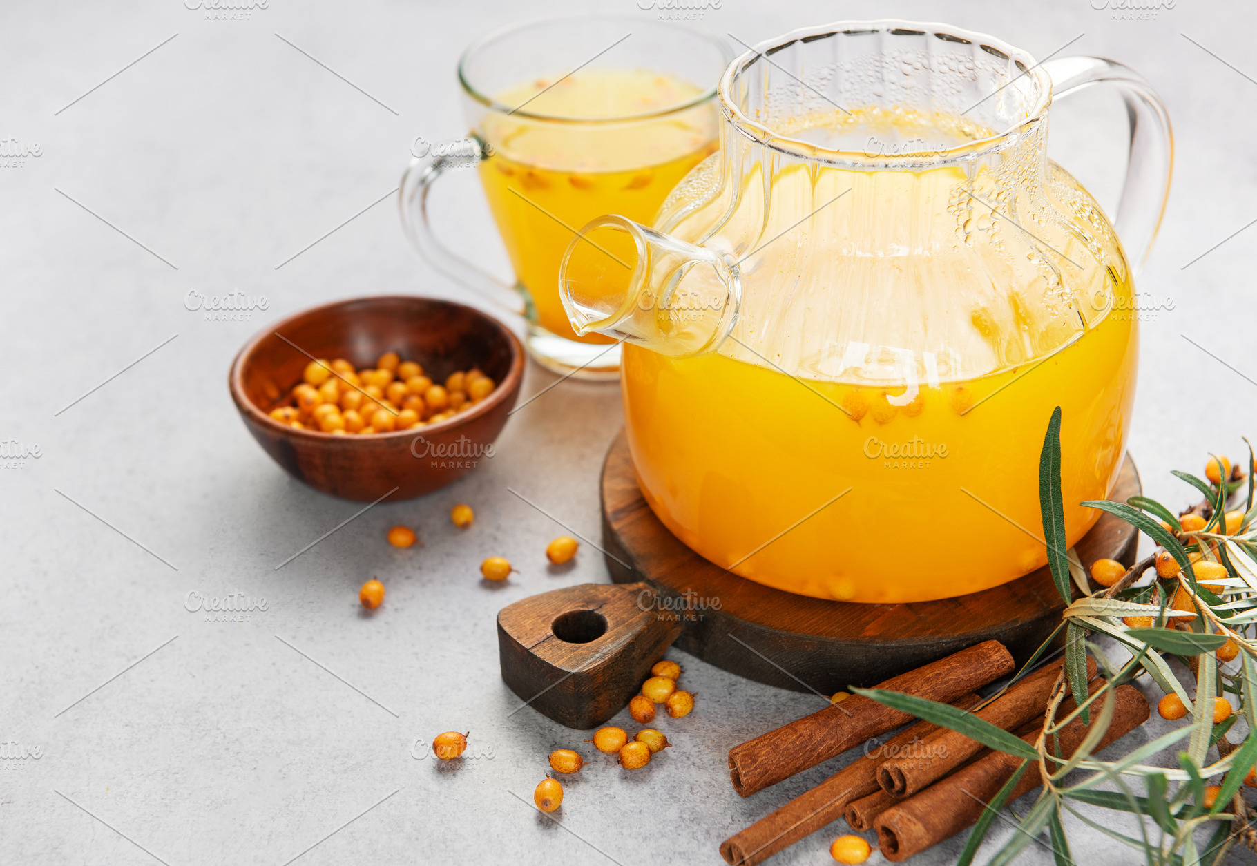 Sea buckthorn tea with cinnamon in a glass teapot, a Food & Drink Photo by Olena Rudo