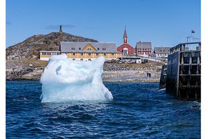 Iceberg with Hans Egede statue on, an Architecture Photo by Backyard Stock