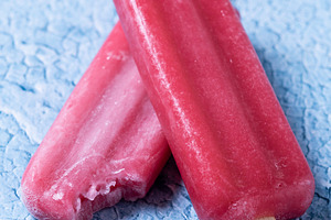 Red strawberry popsicles on blue bac, a Food & Drink Photo by etorres69