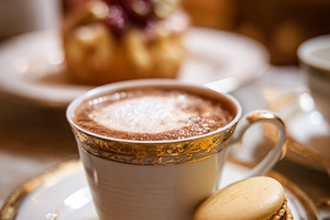 Gourmet hot beverage with macaron on elegant tableware, enjoying, a Food & Drink Photo by Studio ANNA