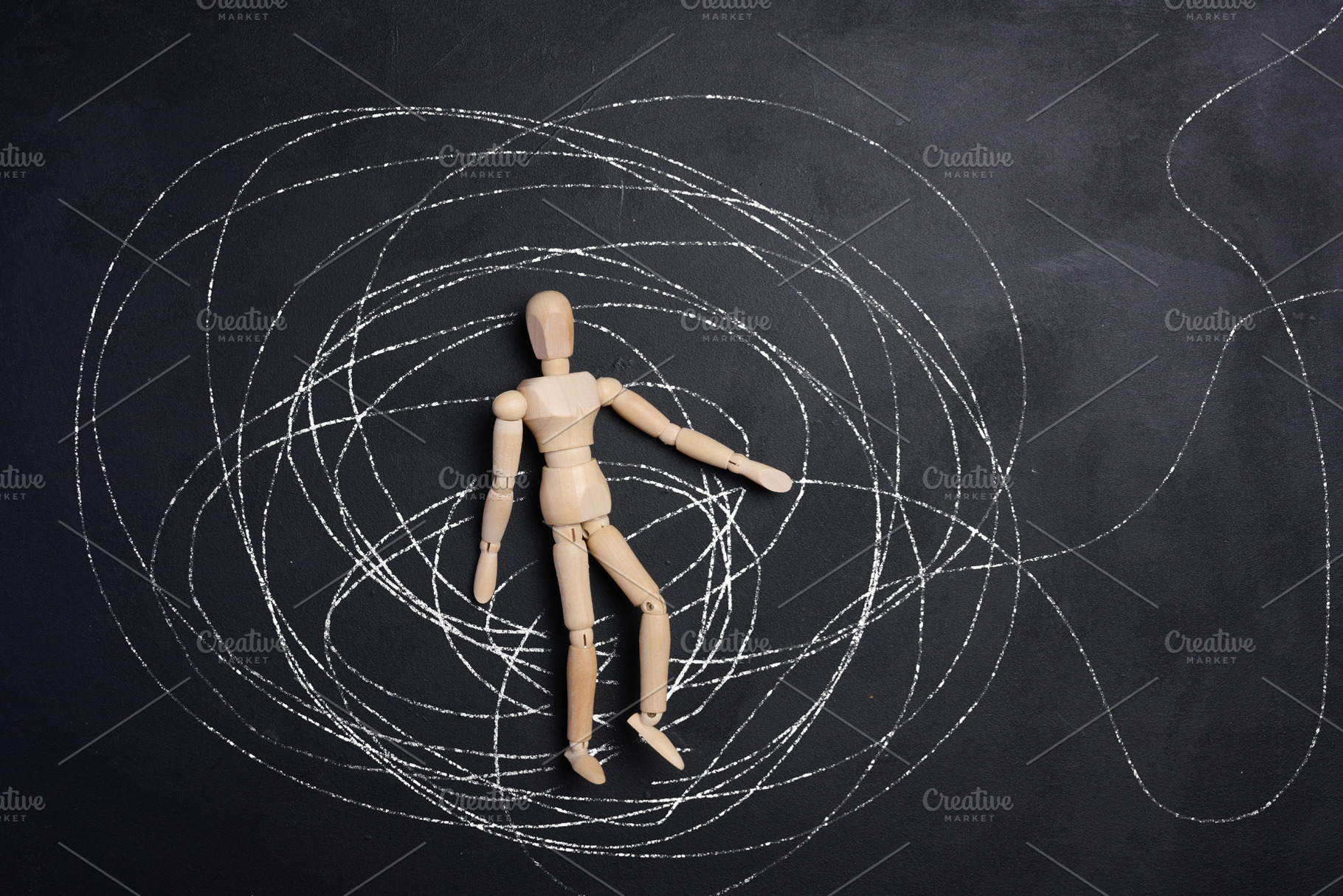 A wooden, articulated figure of a man lies in the center of a ch, an Abstract Photo by ndanko