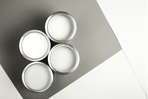 White paint cans on a gray and white, a Background Photo by Anna Efetova
