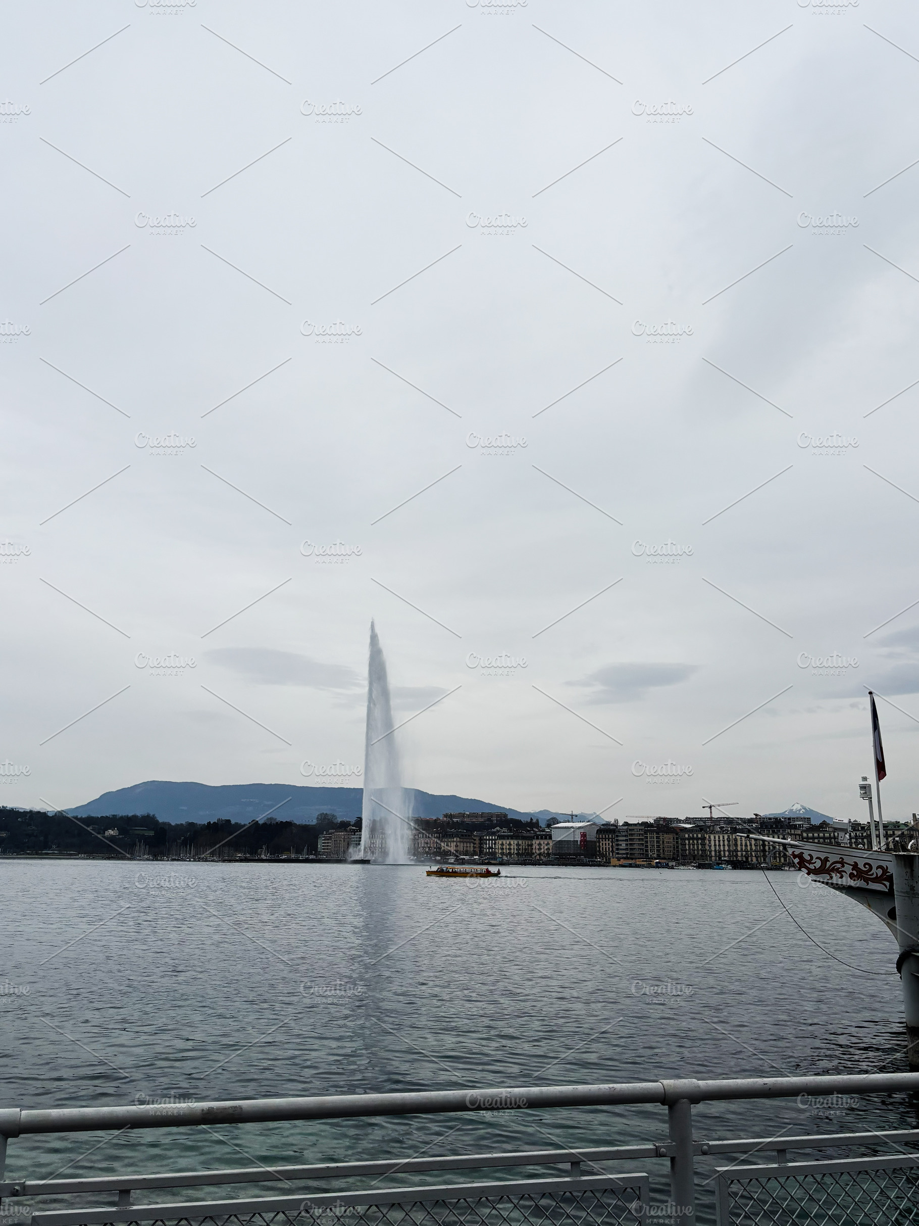 Fountain on the lake in Geneva, Switzerland with scenic cloudy sky backdrop, a Photo by AS photostudio