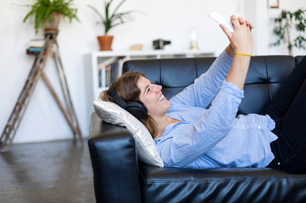 Happy young woman taking self photo in loft apartment, a Person Photo by 2Design