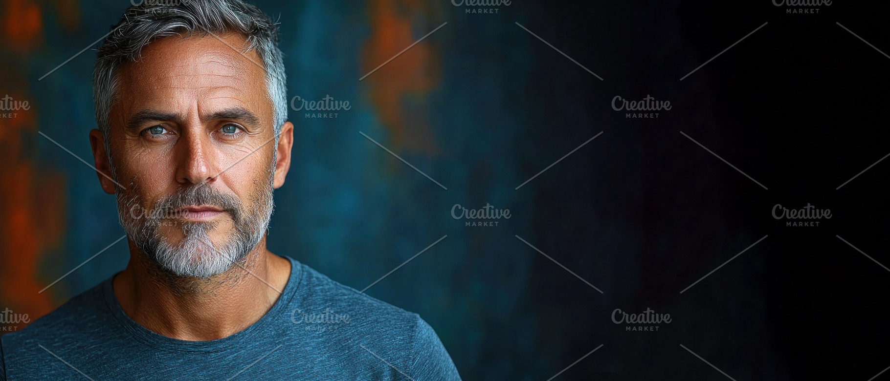 Serious mature man with gray hair and beard wearing a blue shirt, a Person Photo by José Manuel Gelpi