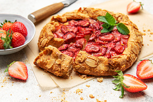 Delicious homemade strawberry galette with almond flakes and fre, a Food & Drink Photo by Olena Rudo