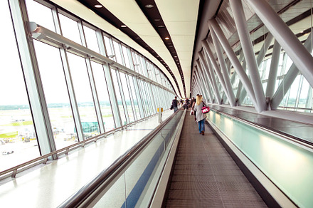 Passengers walking by long corridor,, a Transportation Photo by ariadna de raadt