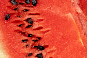 watermelon with pits, part of a sliced juicy watermelon with black seeds, close, a Photo by rsoollAI