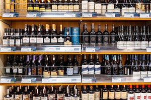 Wine bottles on a shelf in shop, a Food & Drink Photo by BOOCYS