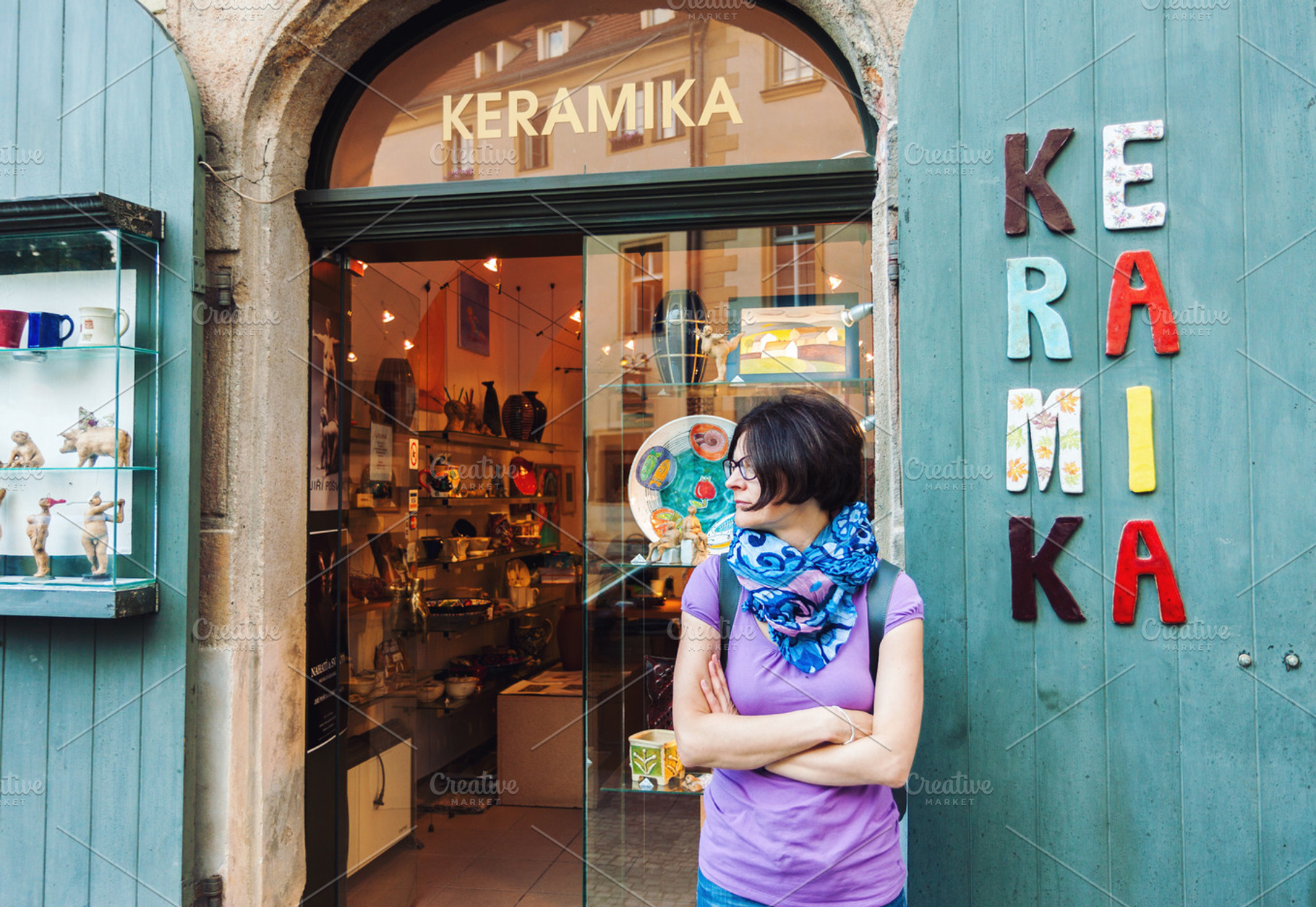 Woman in front of ceramics shop, a Person Photo by BOOCYS