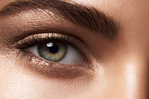 Female eye with shimmer bronze eyeshadow and bold groomed eyebro, a Beauty & Fashion Photo by Studio ANNA