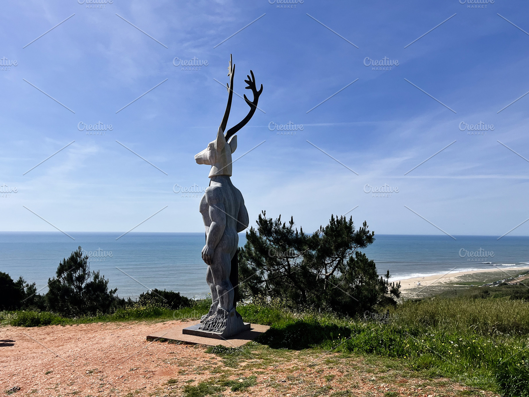 Sculpture of a mythical creature overlooking the sea in Nazare, Portugal, a Photo by AS photostudio