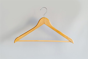 Wooden hanger on white background, an Abstract Photo by AlyaAnd
